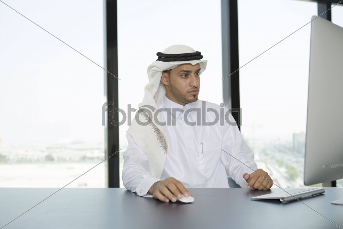 Arab man in the office using a computer