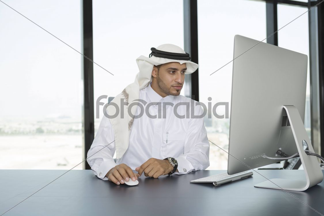 Arab man in the office using a computer