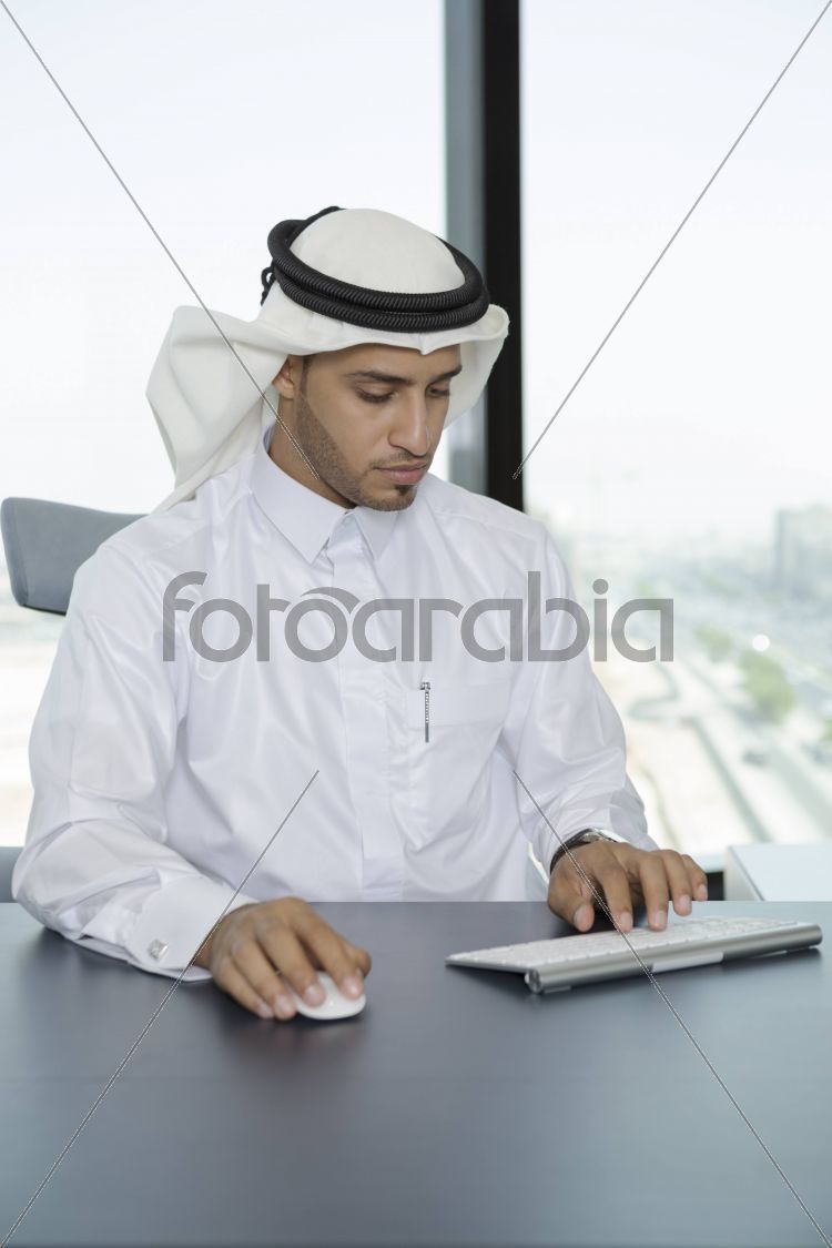 Arab man in the office using a computer