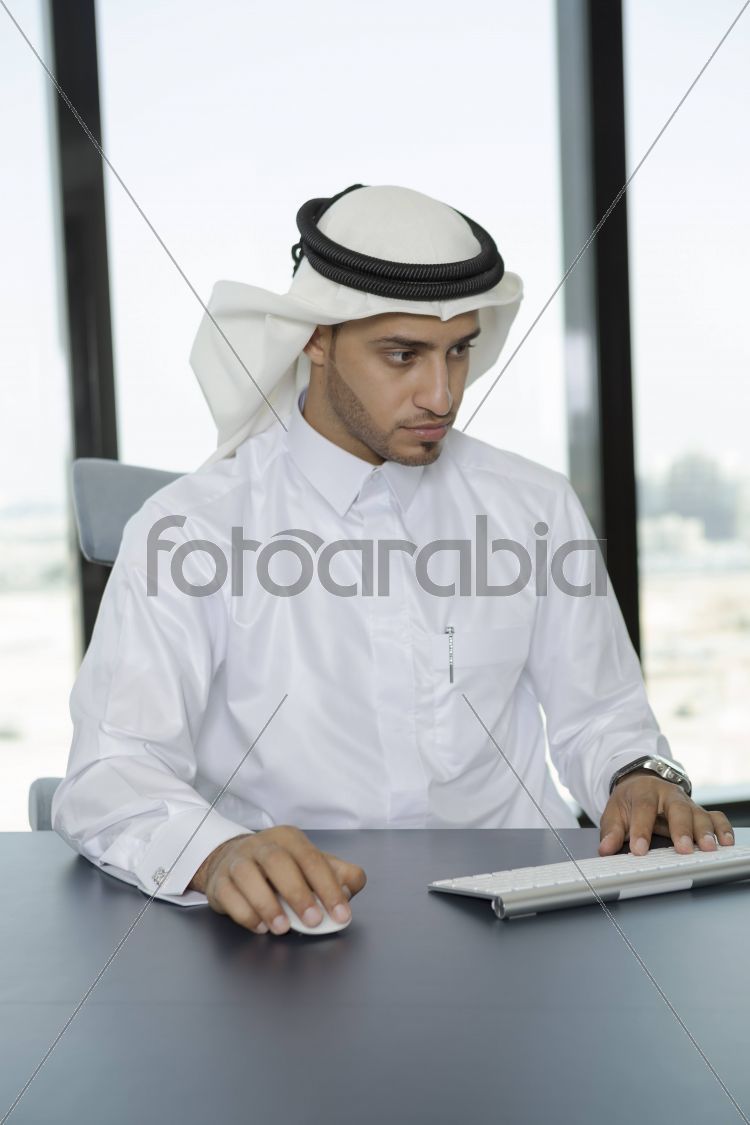 Arab man in the office using a computer