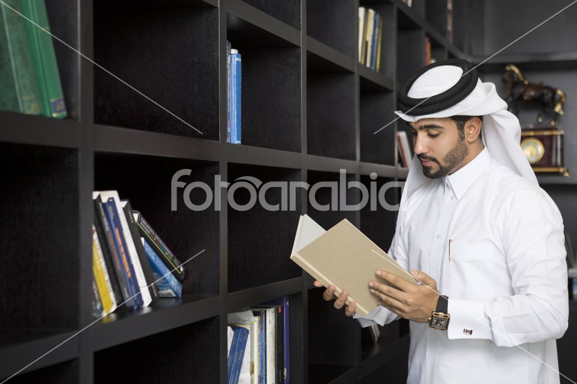 Arab man reading a book