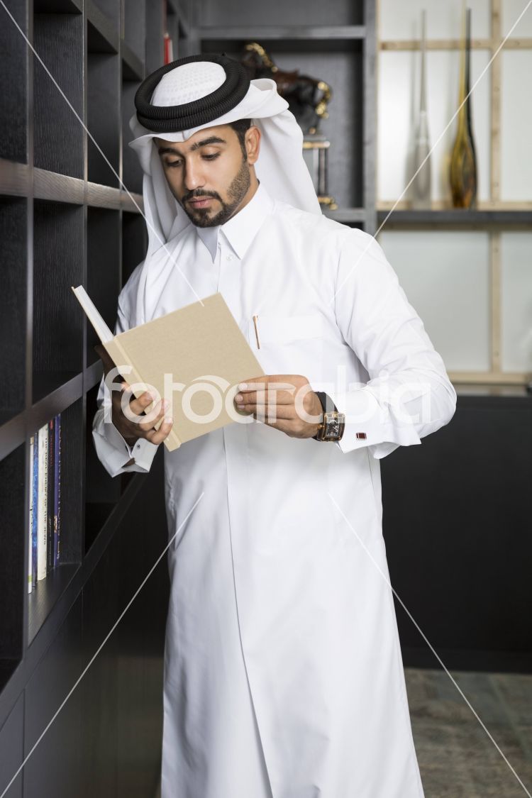 Arab man reading a book