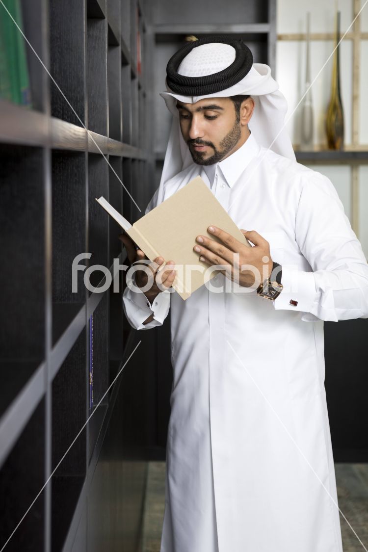 Arab man reading a book