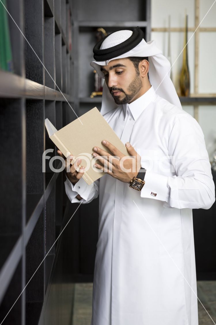 Arab man reading a book