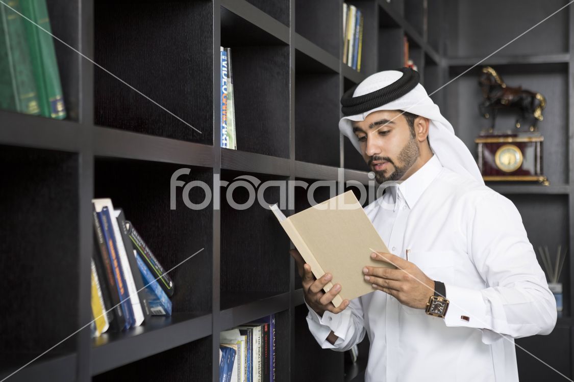 Arab man reading a book