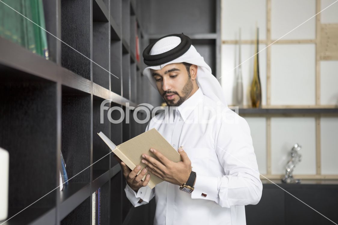 Arab man reading a book