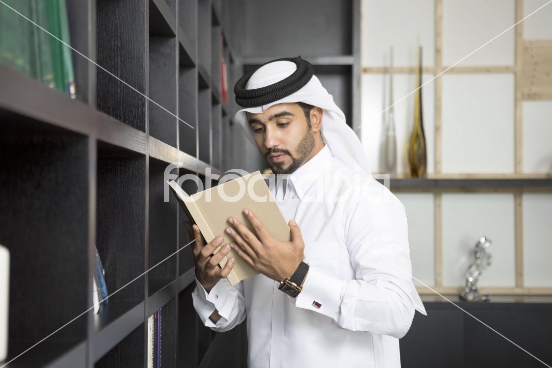 Arab man reading a book