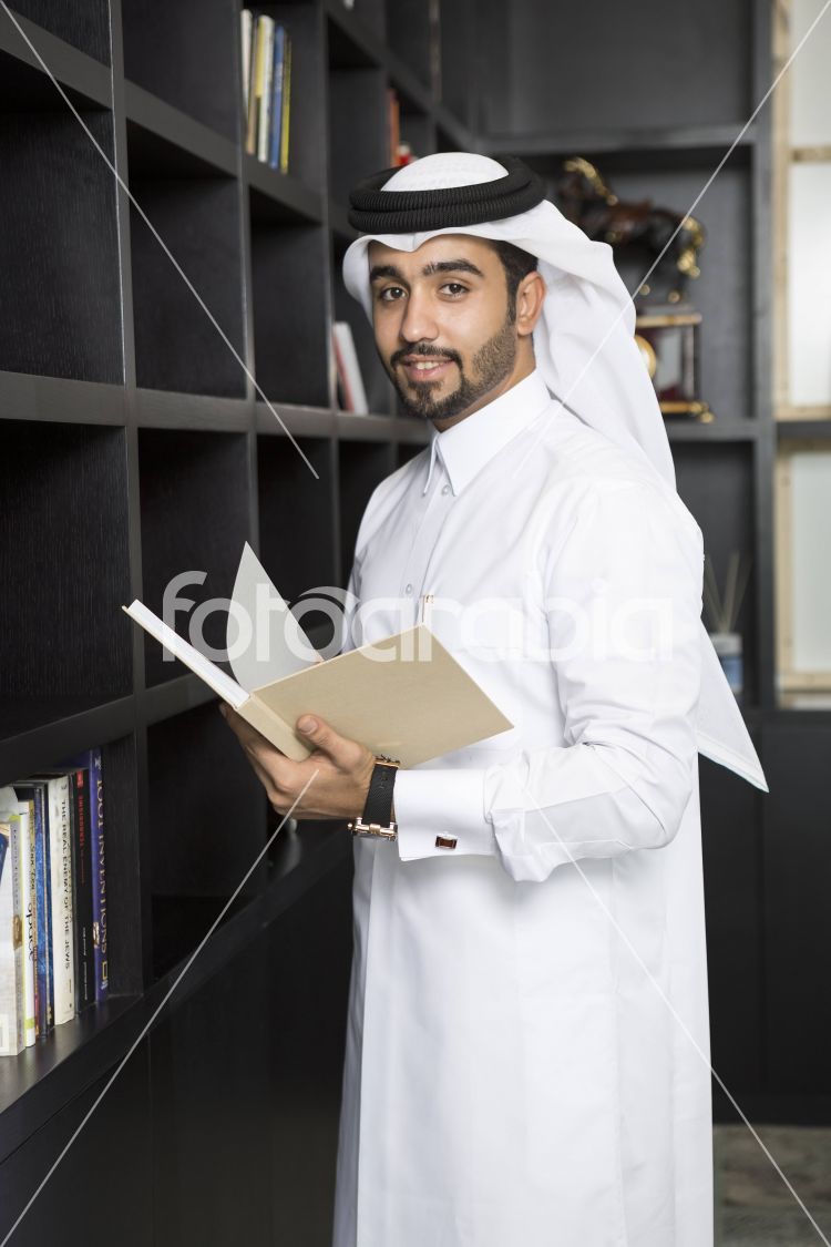 Arab man holding a book