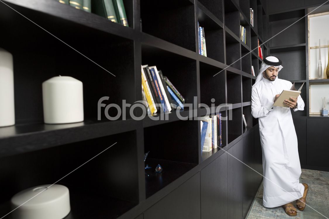 Arab man reading a book