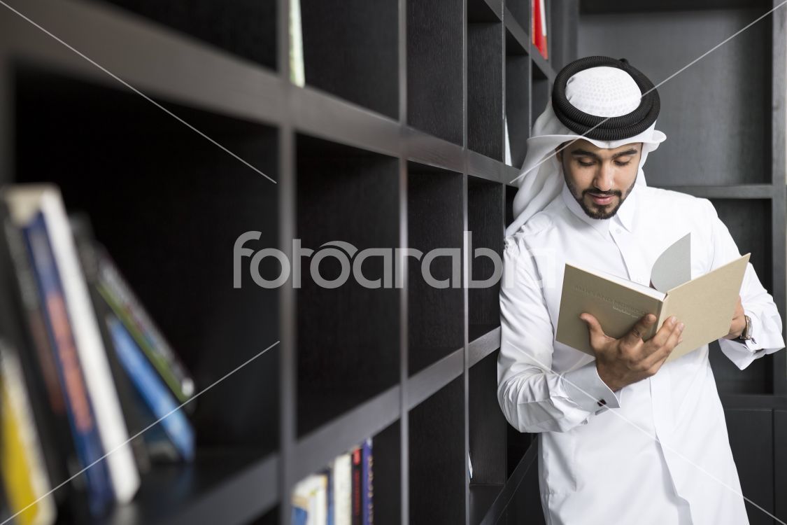 Arab man reading a book