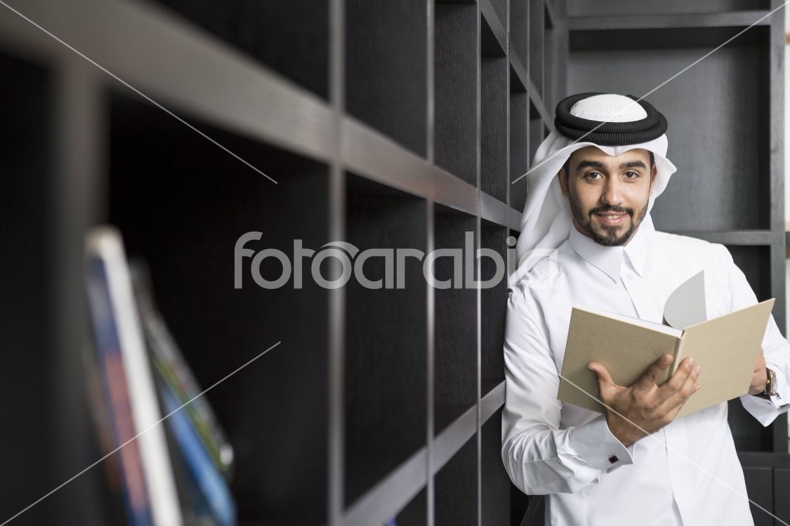 Arab man holding a book