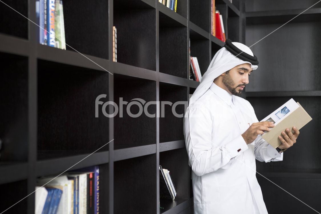 Arab man selecting a book