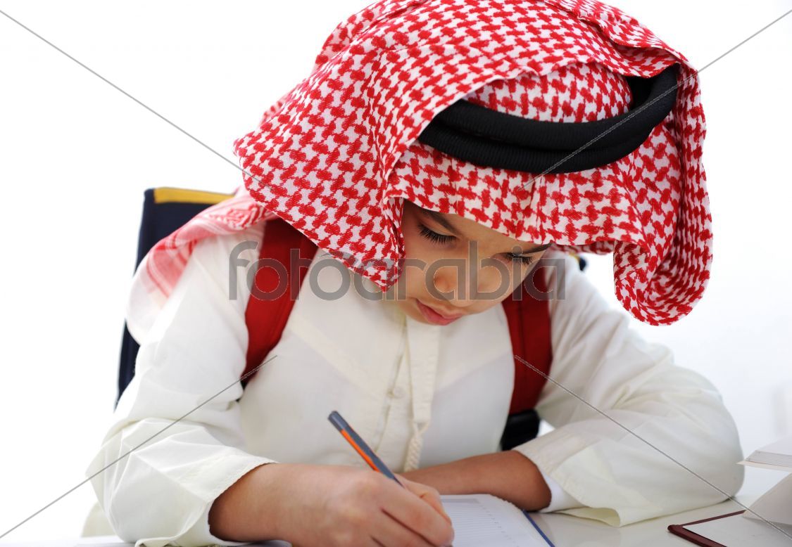 Arabian kid writing on the table
