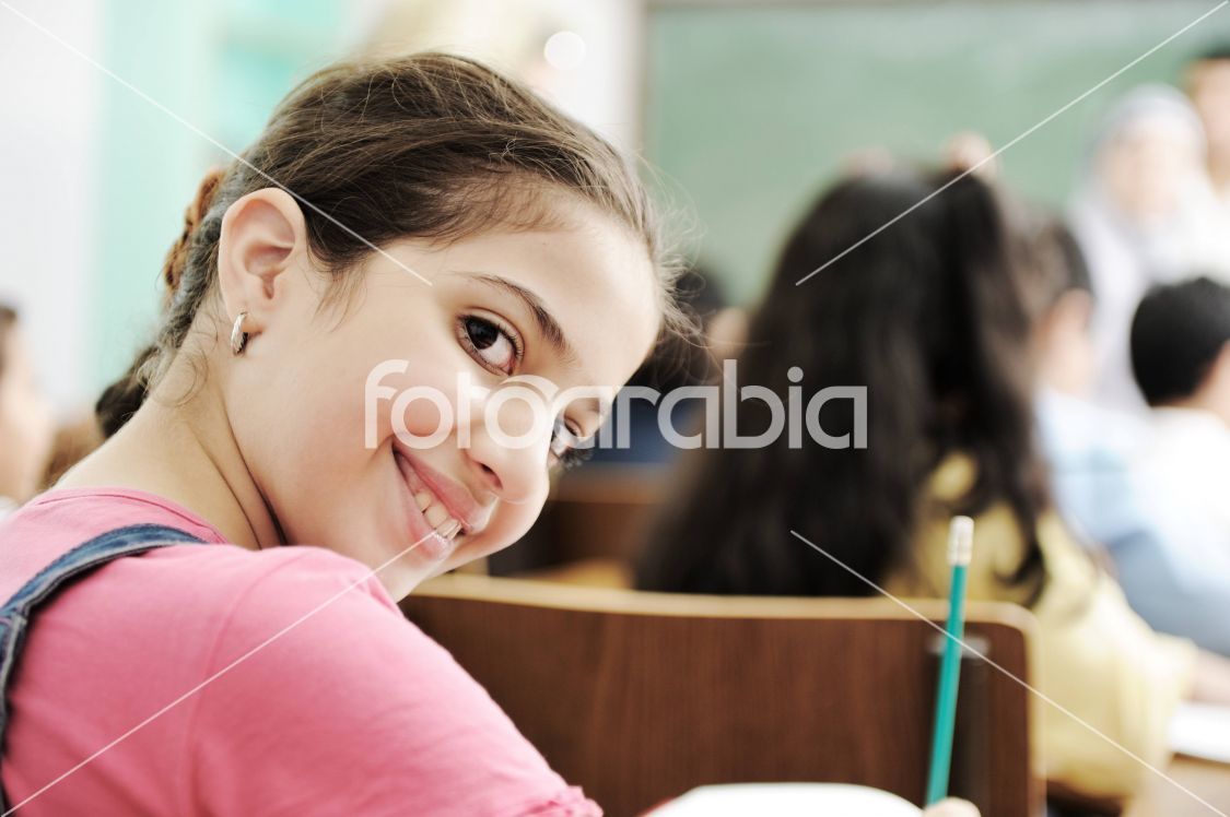 Happy children smiling and laughing in the classroom