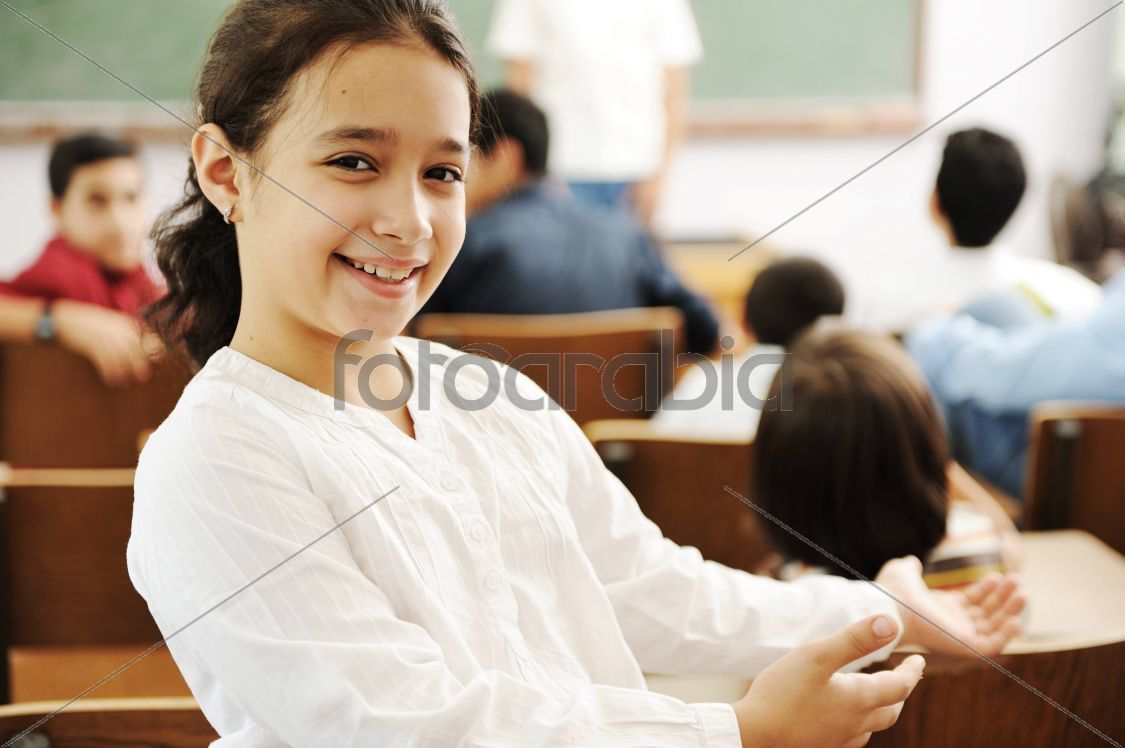 Happy girl smiling and laughing in the classroom