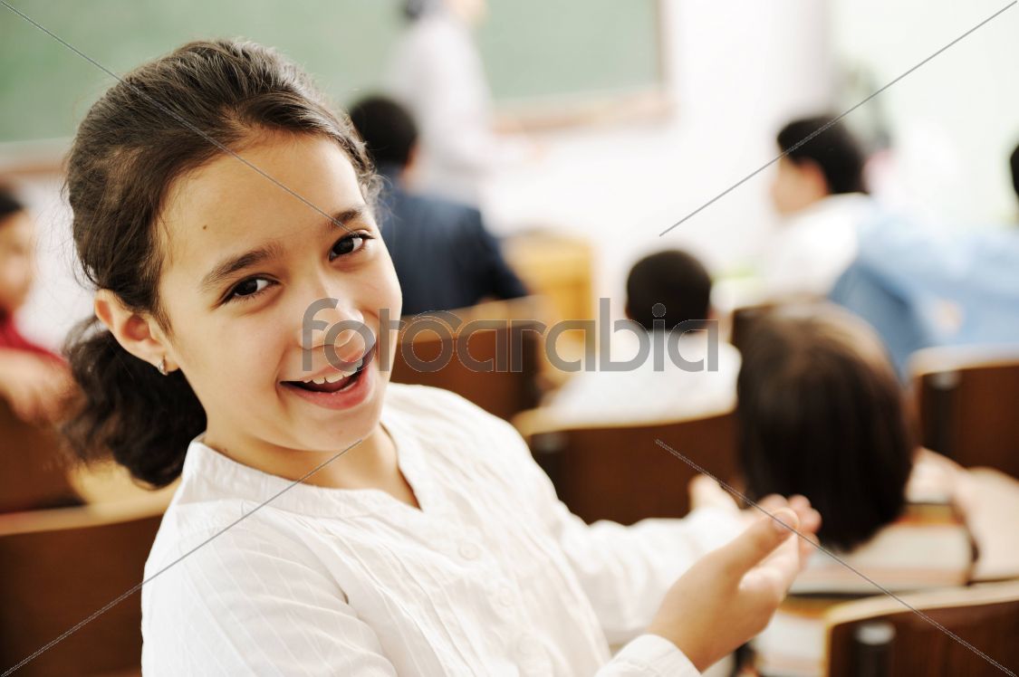 Happy girl smiling and laughing in the classroom