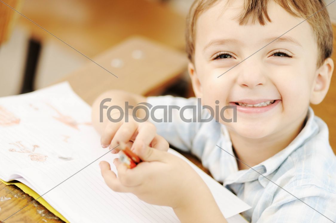 Happy children with their teacher in classroom, doing