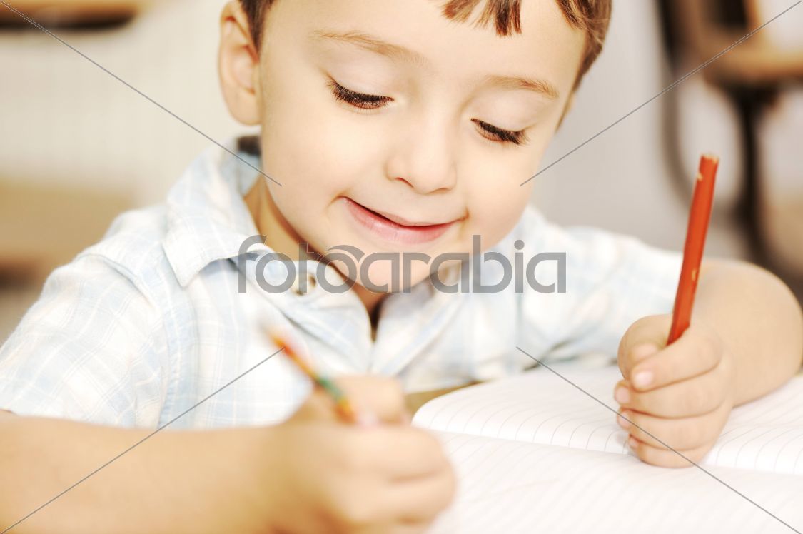 Happy children with their teacher in classroom, doing
