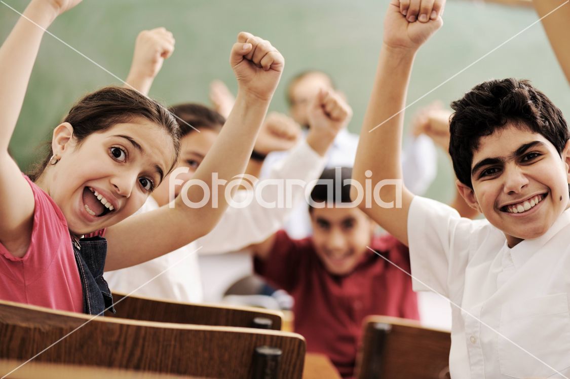 Happy children smiling and laughing in the classroom