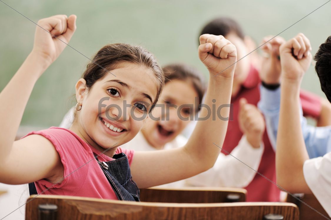 Happy children smiling and laughing in the classroom