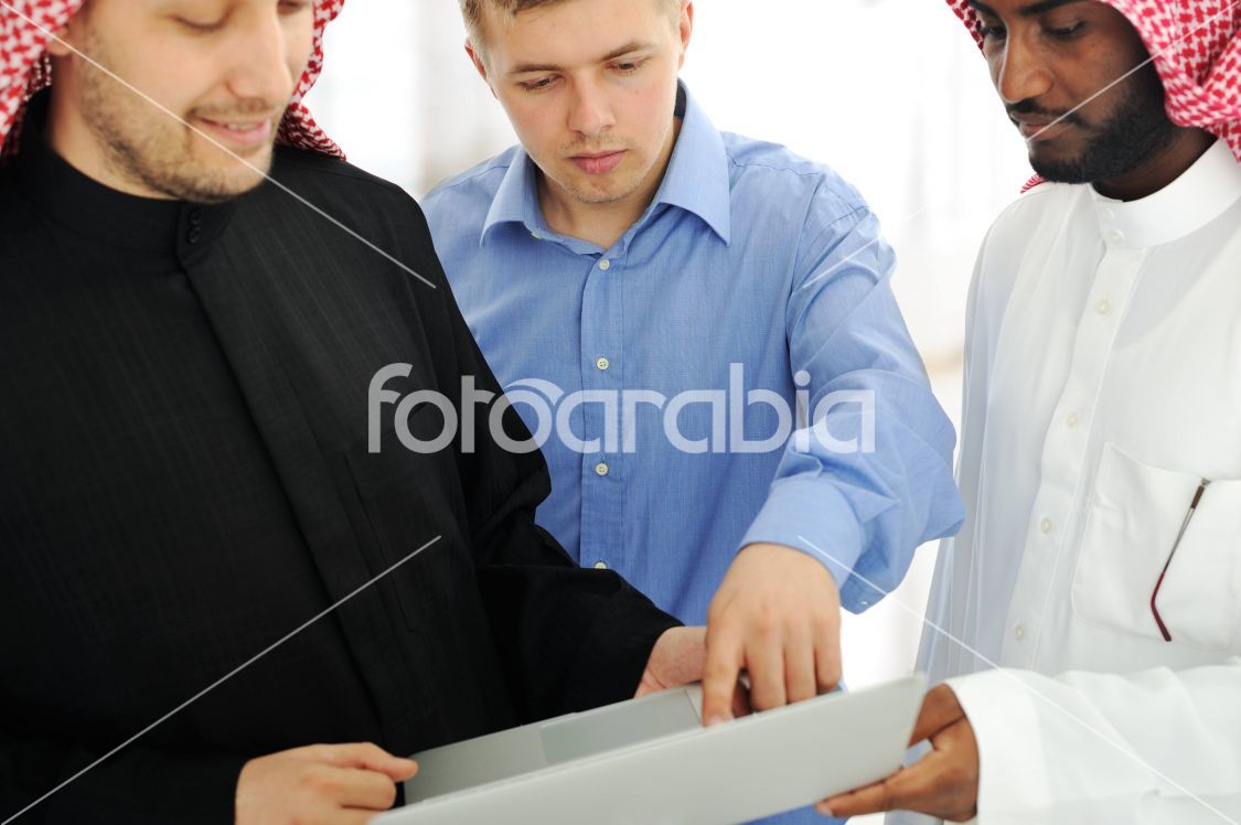 A business team of three planning work in office