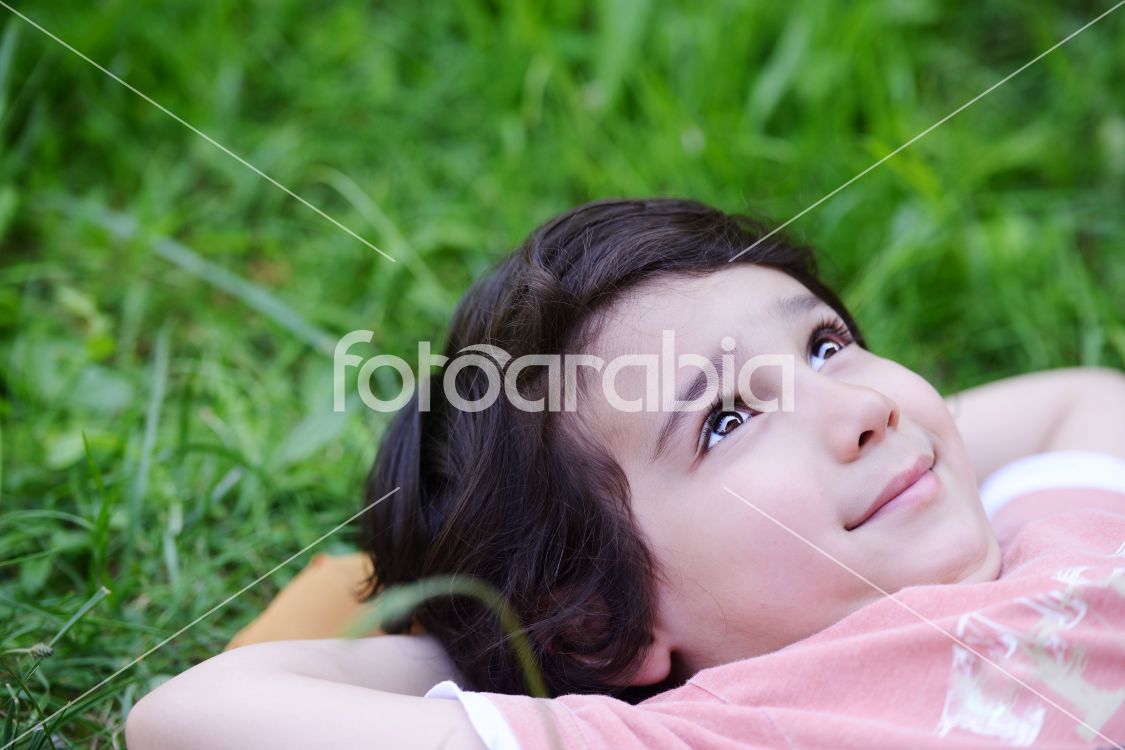 Closeup portrait of a little happy boy outside