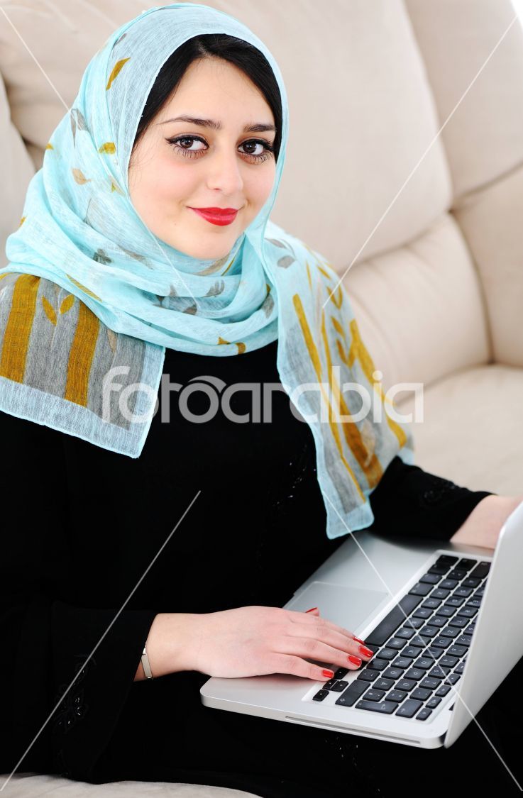 Asian Arabic young with laptop on sofa