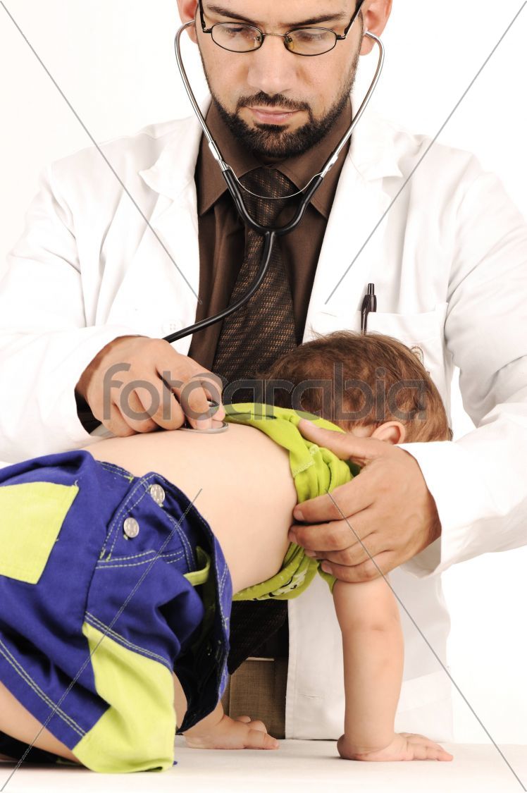 Doctor examining little baby boy