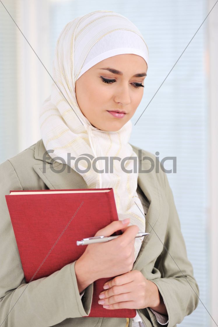 Muslim Caucasian female student with notebook and pen