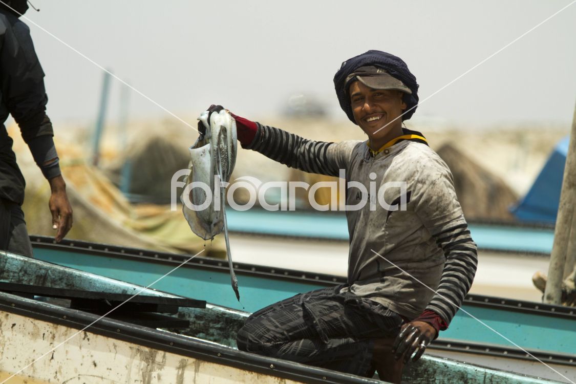 Omani Al Ashkharah fishing boy with squid catch
