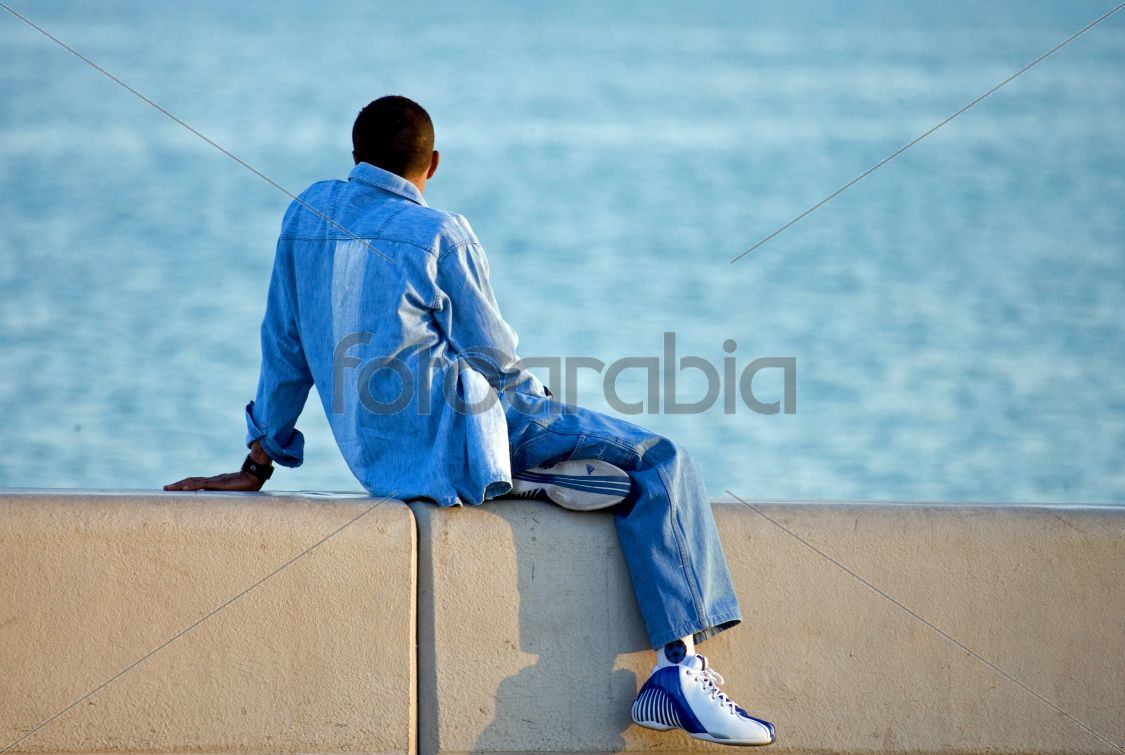 Man sitting along Corniche