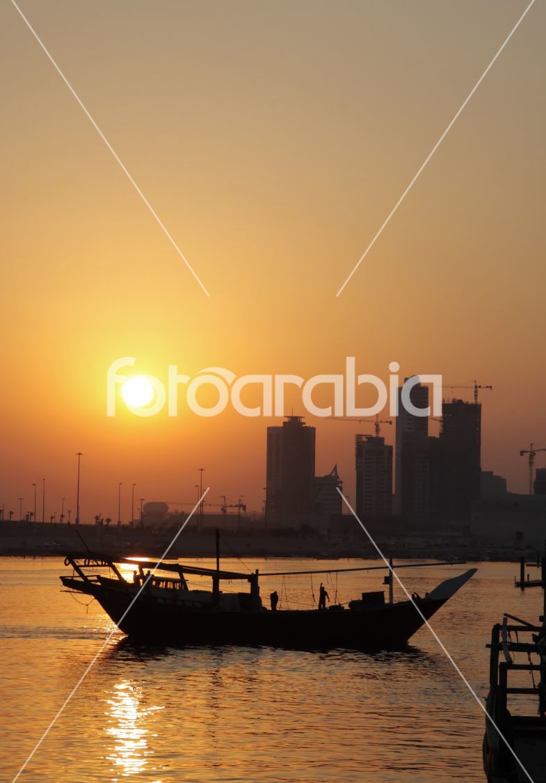 Dhow moving out to the sea during sunset