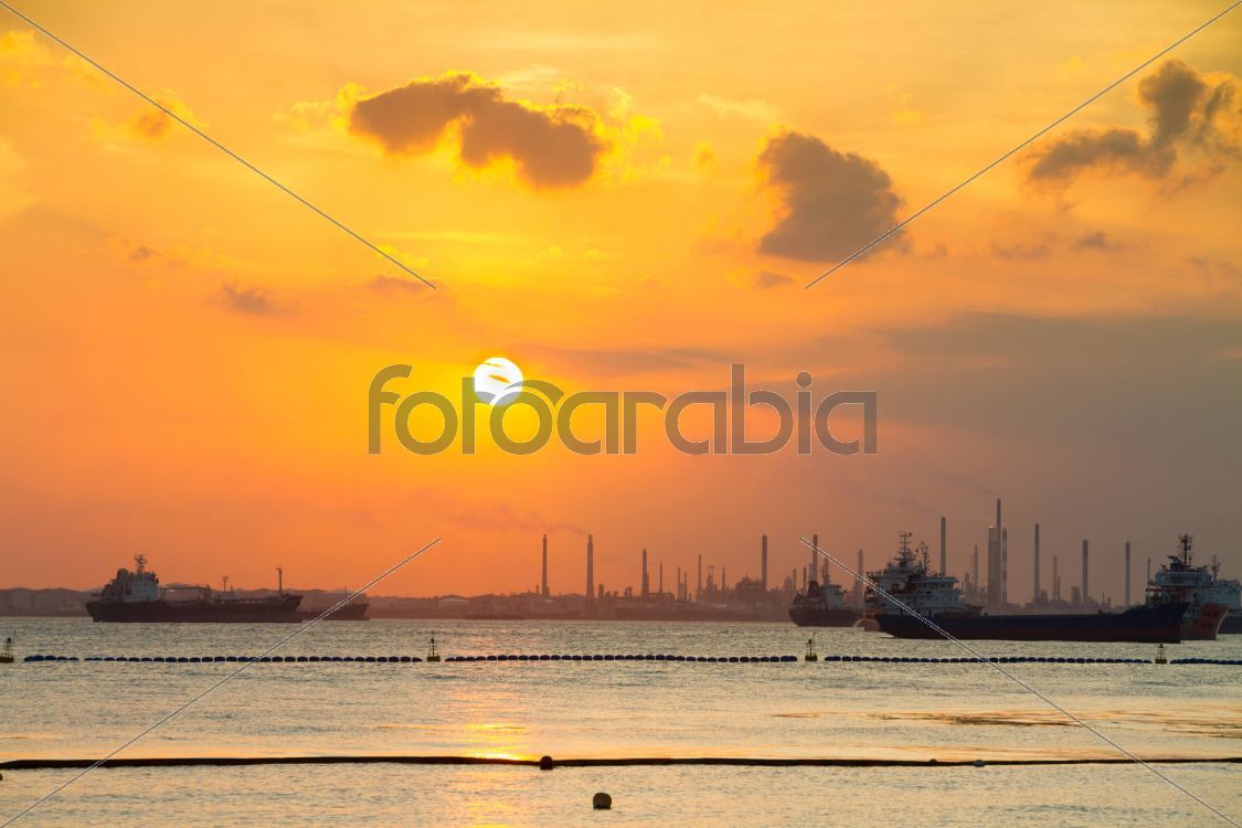 Tanker ships in front of refinery.