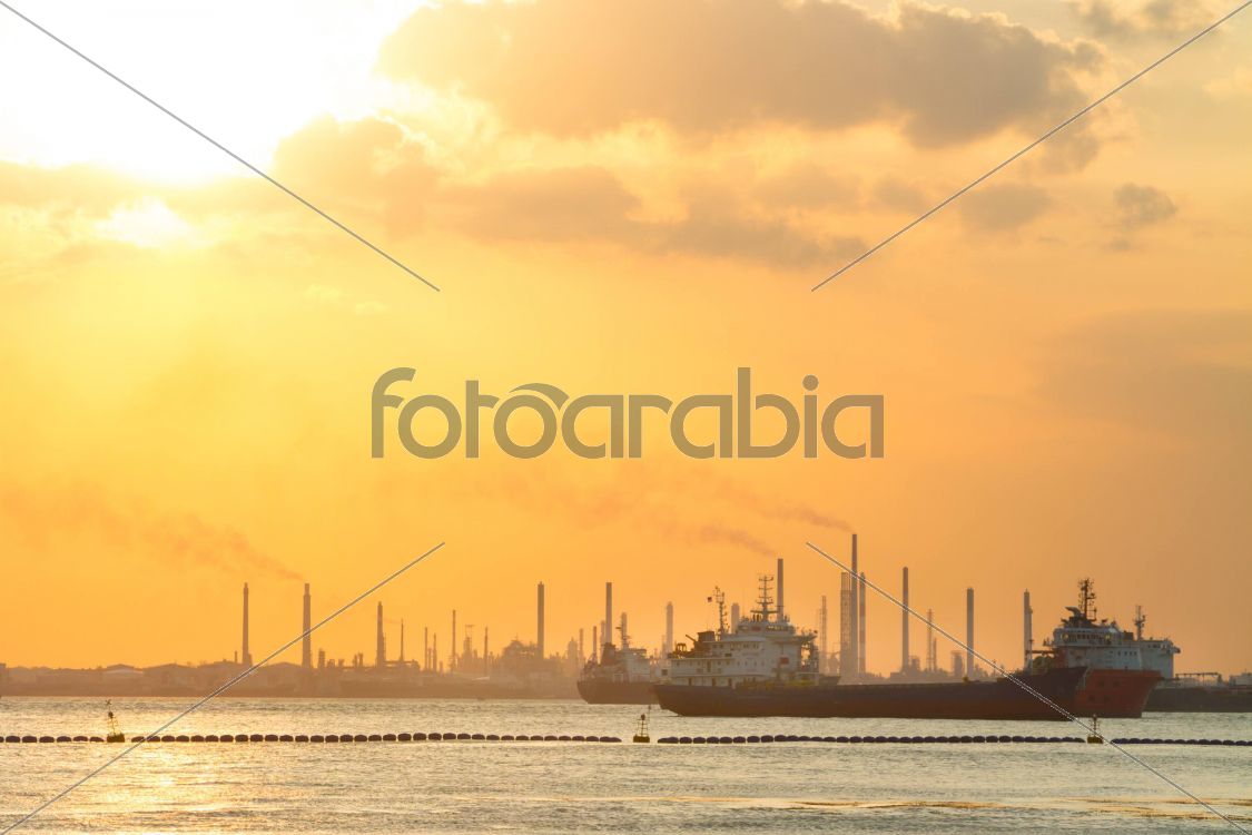 Tanker ships in front of refinery.
