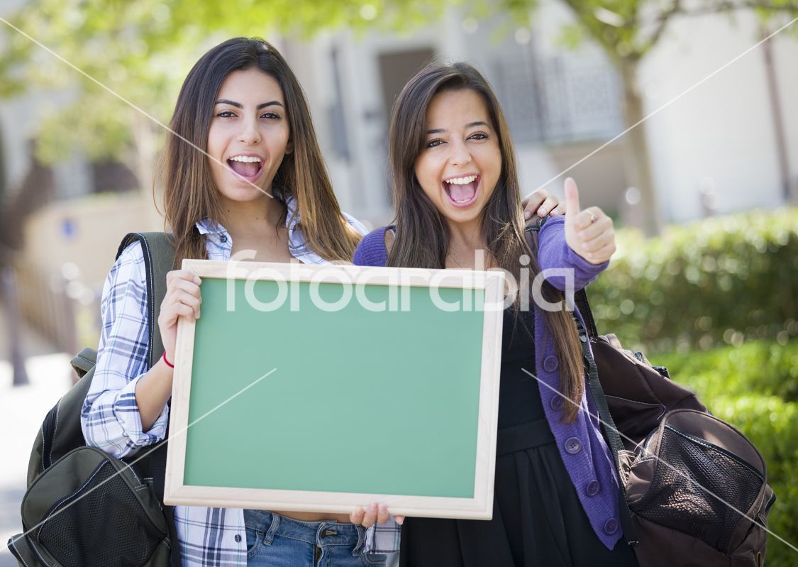 Mixed Race Female Students with Thumbs Up Holding Blank Chalkboa