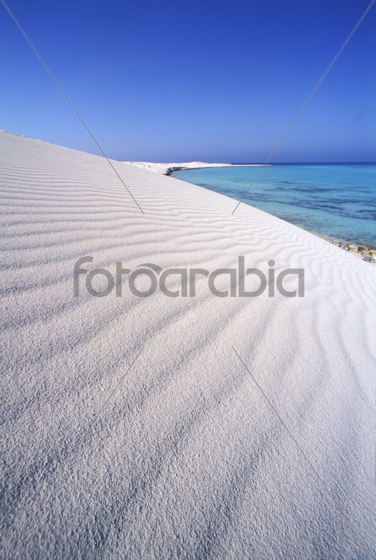 dunes of white sand on the sea