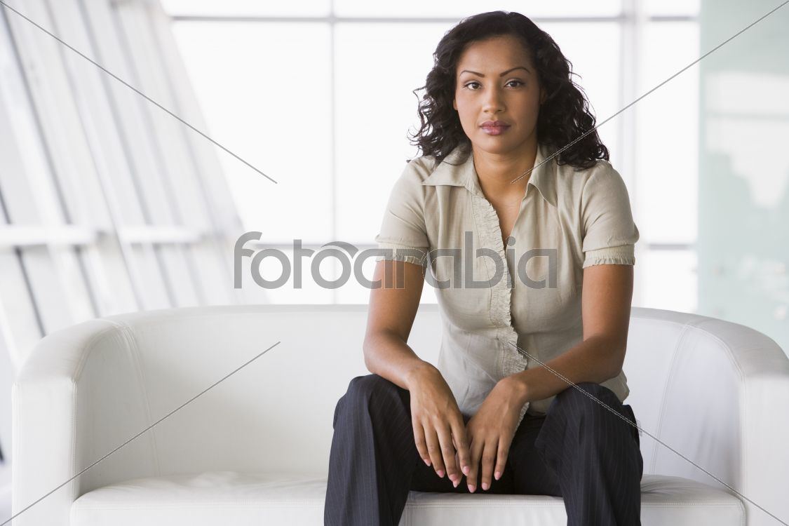 Businesswoman sitting on sofa in lobby