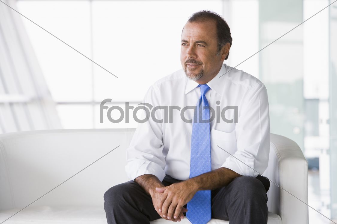 Businessman sitting on sofa in lobby