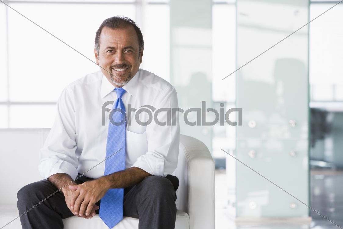Businessman sitting on sofa in lobby