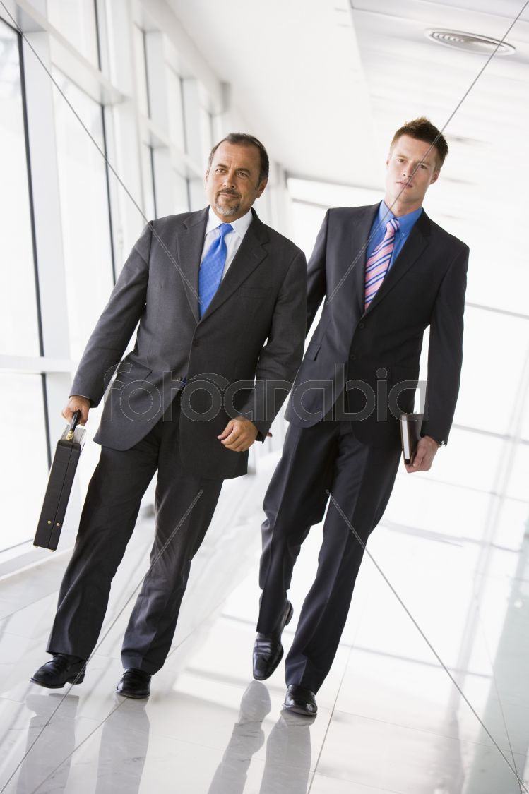 Two businessmen walking through lobby
