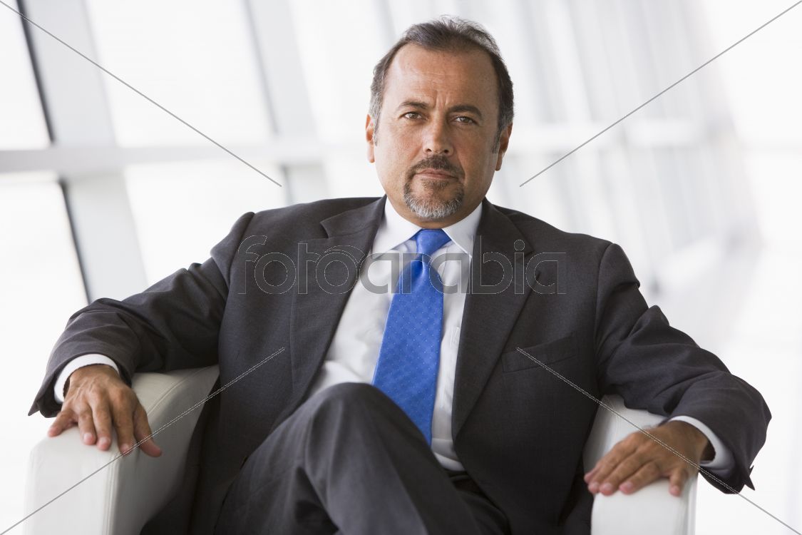 Businessman sitting in chair in lobby