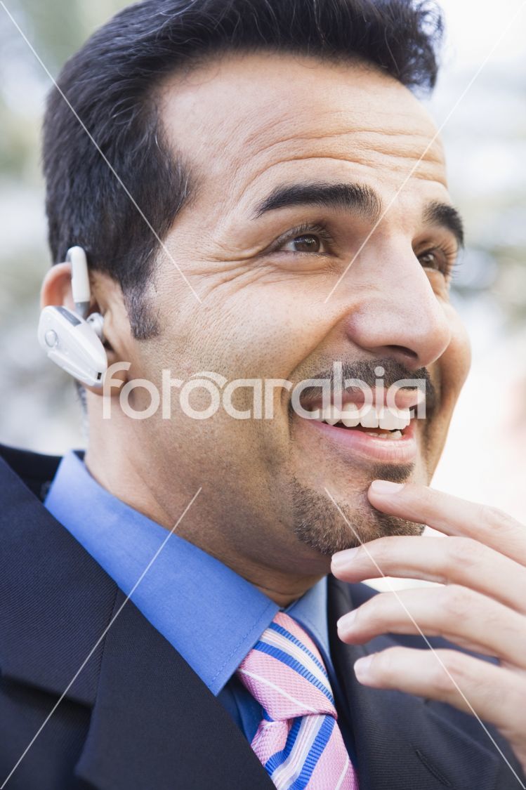 Businessman using bluetooth earpiece