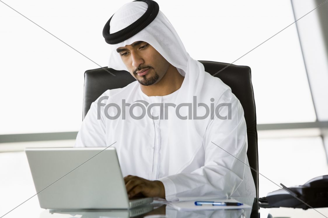 A Middle Eastern businessman using a laptop