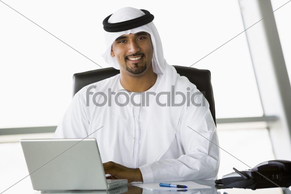 A Middle Eastern businessman using a laptop