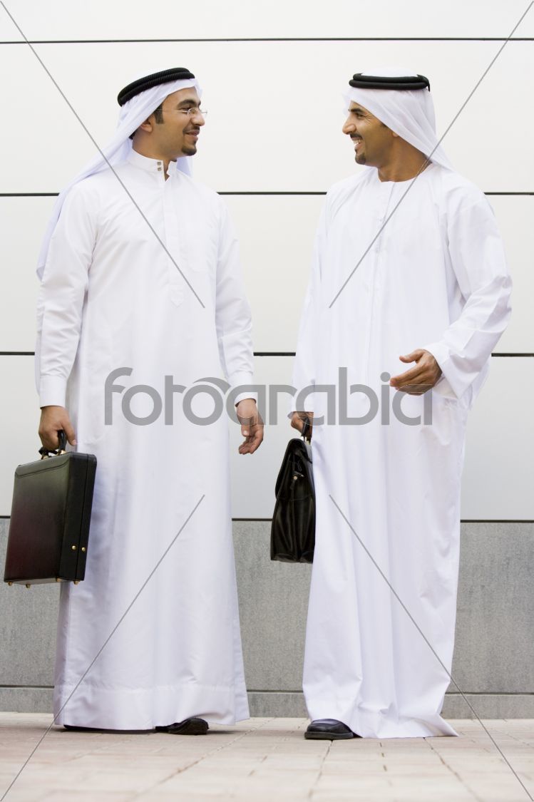 Two Middle Eastern businessmen holding briefcases