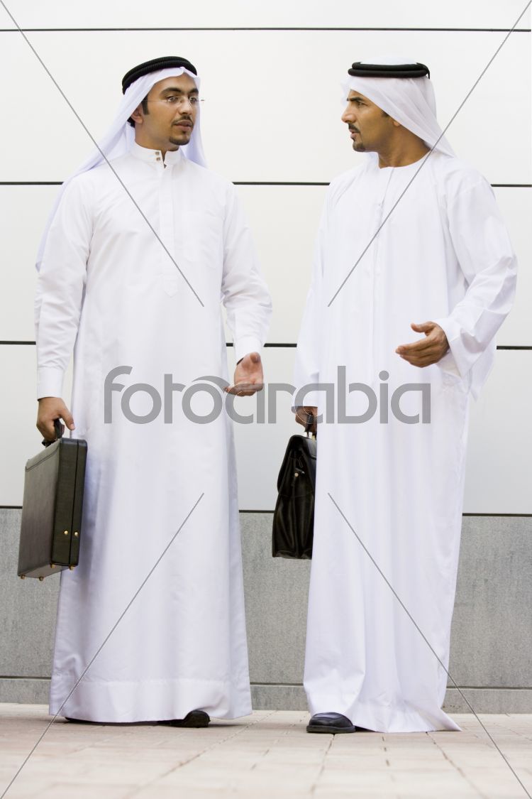 Two Middle Eastern businessmen holding briefcases