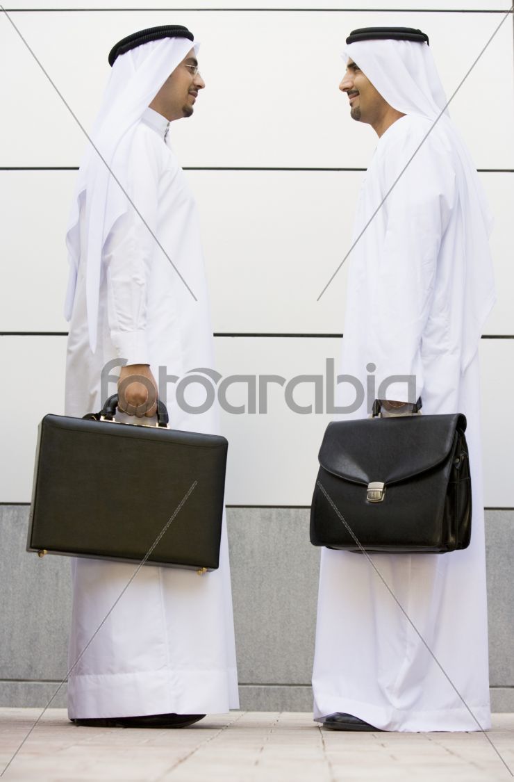 Two Middle Eastern businessmen holding briefcases
