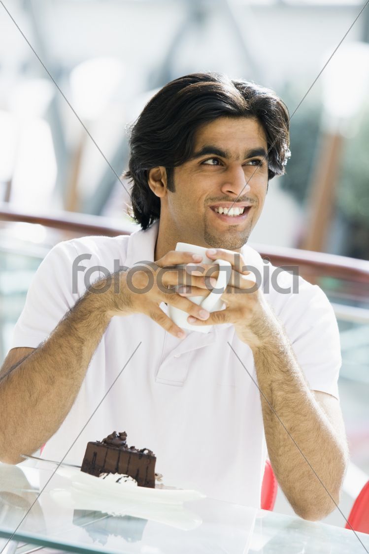 Man drinking coffee in cafe