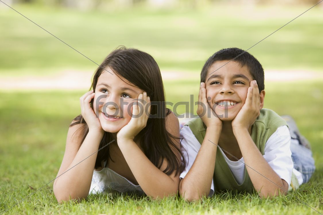 Two children relaxing in park