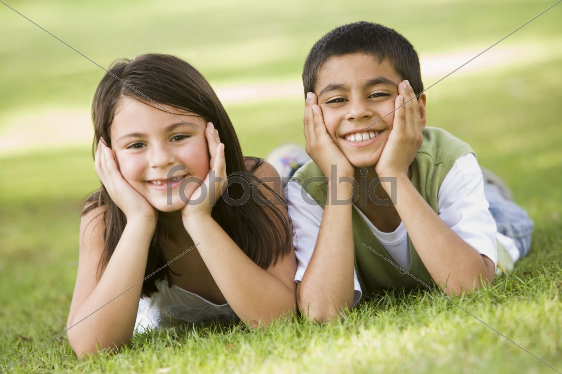 Two children relaxing in park